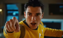 an attractive young man pointing at the camera
