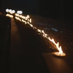 an image of many candles burning on the ground