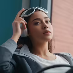 a young woman wearing sunglasses talking on her cellphone