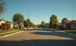 a small, quiet street is surrounded by houses