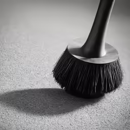 black and white photograph of a broom dust pan head