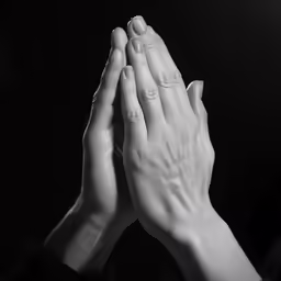hands clasped up with the fingers on top of each other