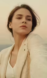 a woman is shown sitting in the sand