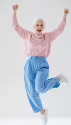 the young woman is jumping in the air