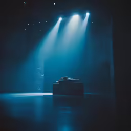 a stage scene with light coming through the lights