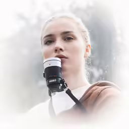 a young woman wearing a camera strap