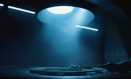 a dj in a dark room with lighting behind him