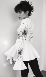 a woman in high heeled shoes is posing