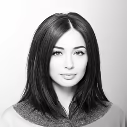 a woman with long black hair is posing for the camera