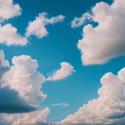 an airplane is flying on the cloudy sky