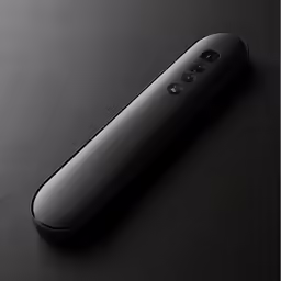 a black remote is displayed on a table