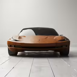 an orange sports car parked in a white room