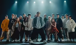 a group of people are standing together in front of lights