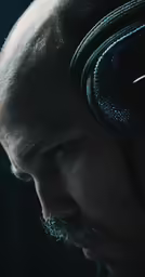 a man is looking out in front of a dark background