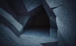 a dark room with a narrow concrete tunnel