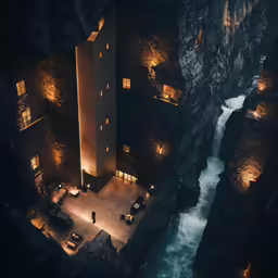 a house made out of a rock with a river in the middle