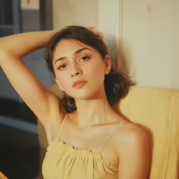 an attractive asian woman in a yellow top