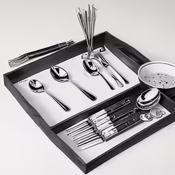 a tray holds a set of utensils, cups and spoons