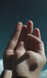 someone holding their hand with one hand with both other above the top