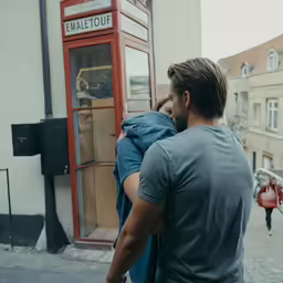 a man is hugging a woman on the street