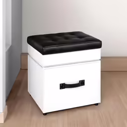 a white stool with black leather top