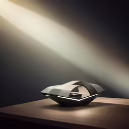 a silver boat on a wooden table in the dark