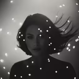 black and white photo of a girl with white lights in her hair
