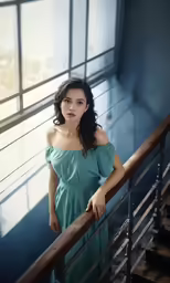 woman with shoulder length dress on top of stairs