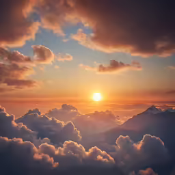 a beautiful sunset over some clouds and mountains