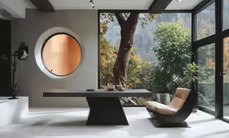 a black and white modern desk in a large room with glass doors
