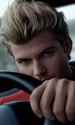 a man sits behind the wheel of a car