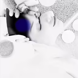 the person is on the bed with the remote