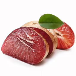 a grapefruit with two slices removed and one sliced into quarters