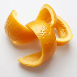 an orange peeled with its core removed sitting on a white surface