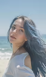 a beautiful young woman standing on top of a beach