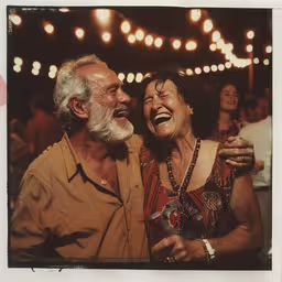 an older couple laughs at a birthday party,an old man and woman enjoying a night out
