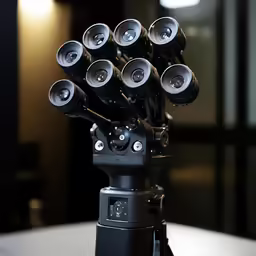 a bunch of cameras that are on top of a camera stand
