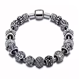 a silver bracelet with hearts and swirls,a bracelet with beads and silver beads on it