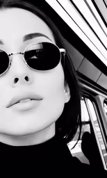 a woman is sitting in the backseat wearing sunglasses