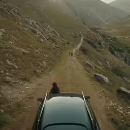 the man is driving down the road on his car