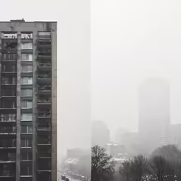 two tall buildings on a city street on a cloudy day