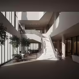 an elegant indoor lobby with stairs and potted plant