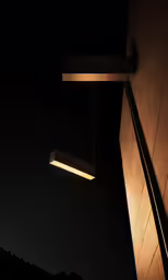 a light fixture hanging from the ceiling in front of a building