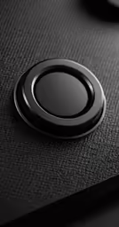 a black surface has a button attached