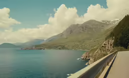 a view down the road near a body of water