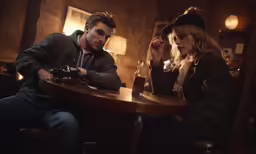 a man holding a camera sitting next to a woman