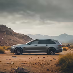 a car parked in the middle of the desert with mountains