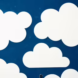 several cloud cutouts set against a blue sky