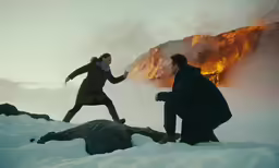 a couple who is kneeling on a rock in the snow