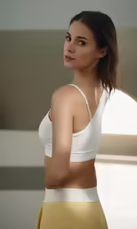 a young woman wearing white tank top and yellow skirt